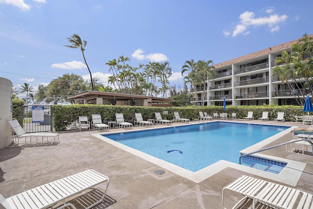 pool featuring fence and a patio