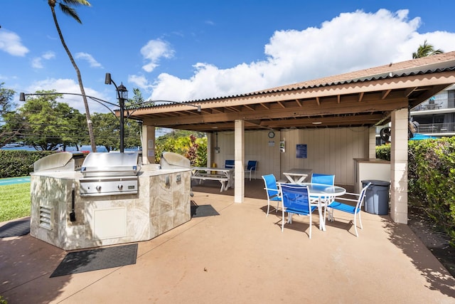 view of patio featuring outdoor dining space, area for grilling, and an outdoor kitchen