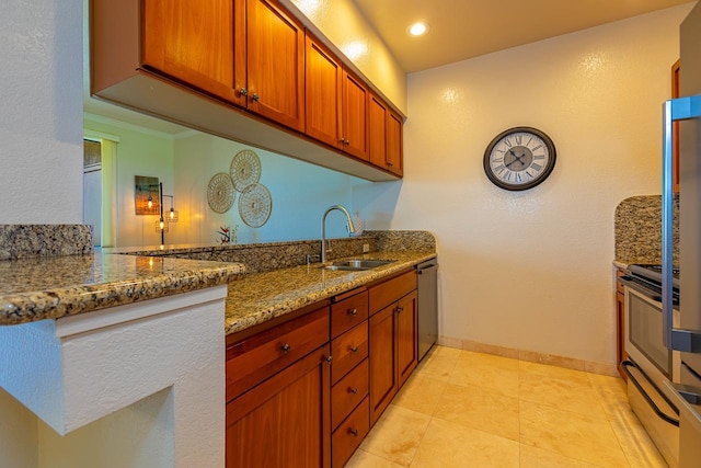 kitchen with appliances with stainless steel finishes, light tile patterned flooring, sink, and stone countertops