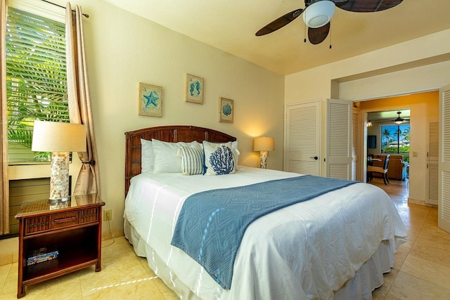 tiled bedroom featuring ceiling fan