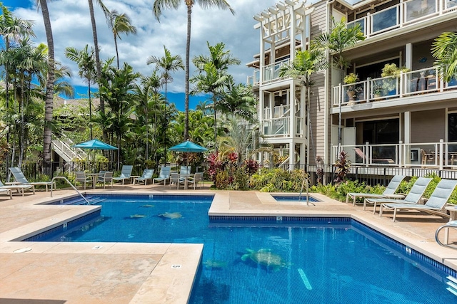 view of swimming pool featuring a patio and a community hot tub