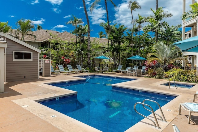 view of swimming pool featuring a patio and a community hot tub