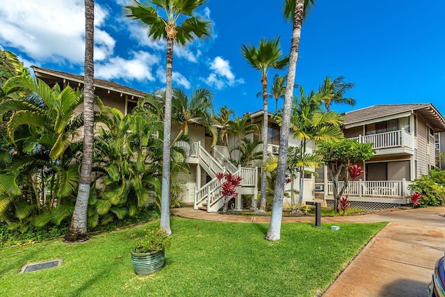 155 Wailea Ike Pl Unit 67, Kihei, HI 96753 - view of front of home featuring covered porch, stairway, and a front lawn