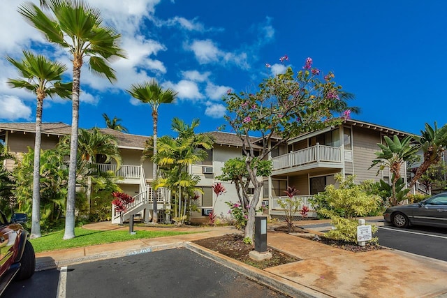155 Wailea Ike Pl Unit 67, Kihei, HI 96753 - view of building exterior with uncovered parking