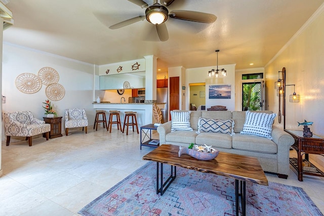 living room featuring ornamental molding and ceiling fan with notable chandelier