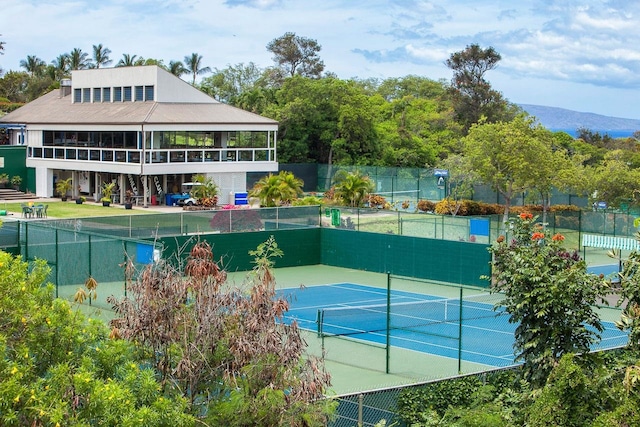 view of tennis court with a gazebo and a mountain view