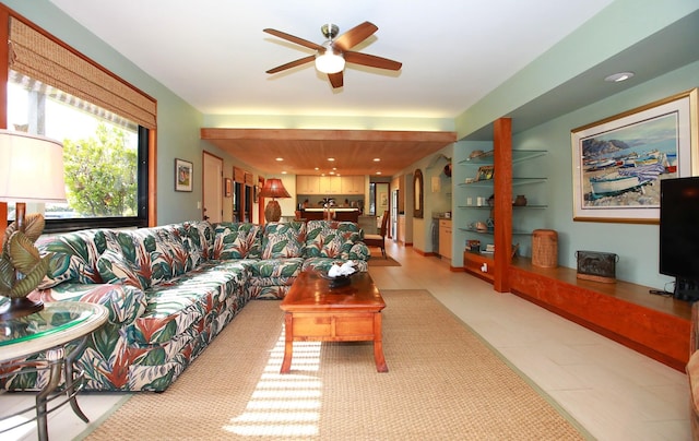 tiled living room with ceiling fan