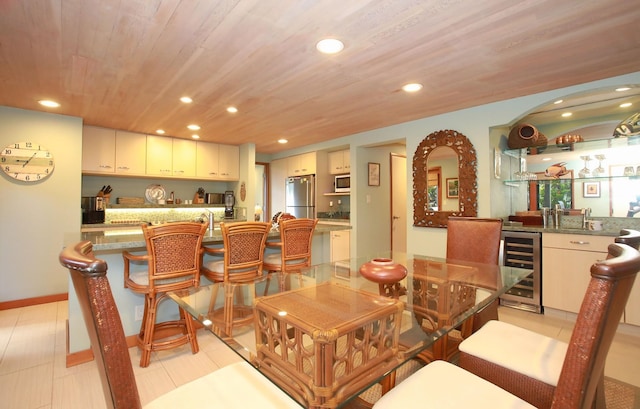 tiled dining space with wooden ceiling and beverage cooler