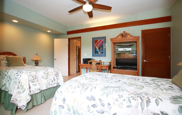 bedroom featuring stainless steel refrigerator and ceiling fan