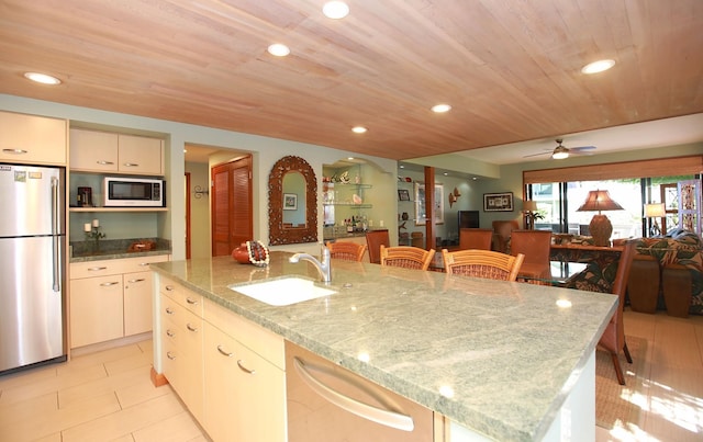 kitchen with wooden ceiling, stainless steel appliances, light tile floors, and an island with sink