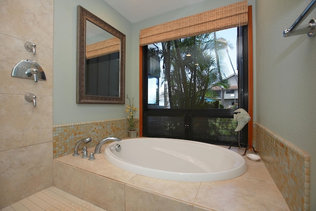 bathroom featuring a relaxing tiled bath