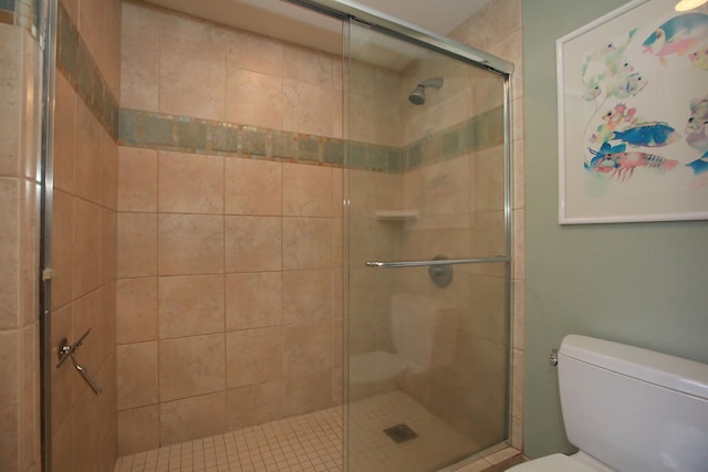 bathroom featuring walk in shower and toilet