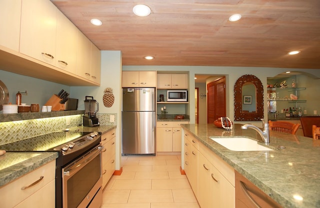 kitchen featuring wooden ceiling, appliances with stainless steel finishes, sink, stone countertops, and light tile floors