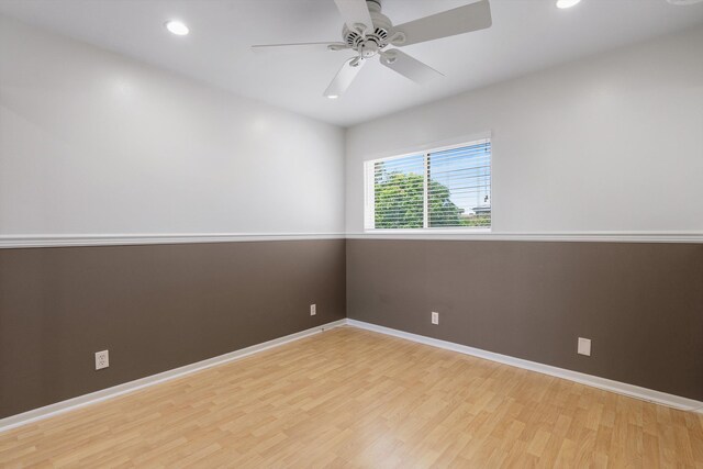 spare room featuring light wood-type flooring and ceiling fan