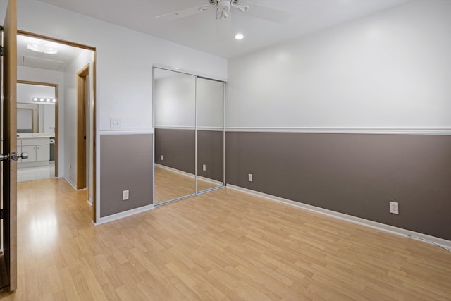 unfurnished bedroom with ceiling fan, a closet, and light hardwood / wood-style flooring