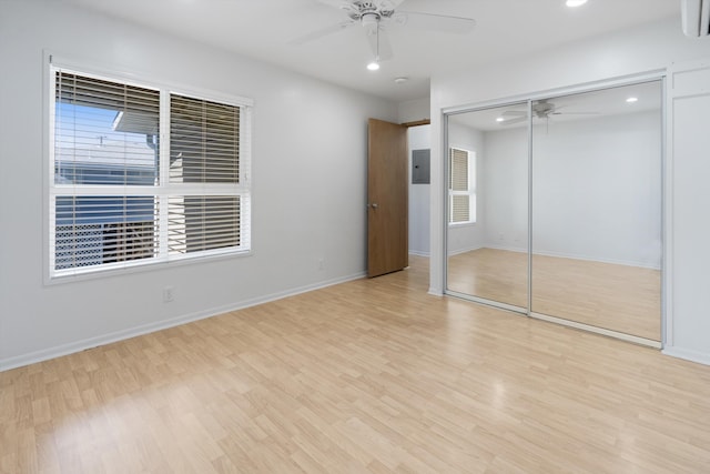 unfurnished bedroom with ceiling fan, a closet, and light hardwood / wood-style floors