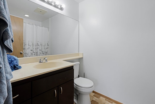 bathroom featuring toilet, vanity, and tile patterned floors