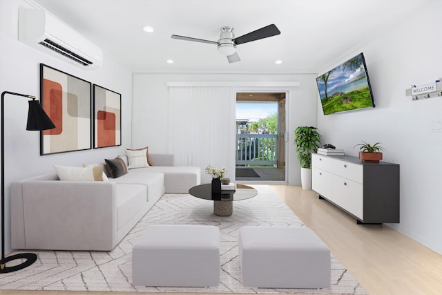 living room featuring ceiling fan, light wood-type flooring, and a wall mounted air conditioner