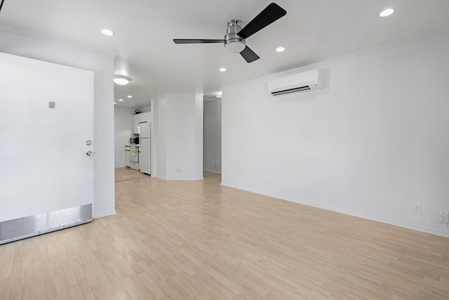 unfurnished room with light wood-type flooring, crown molding, a wall mounted air conditioner, and ceiling fan