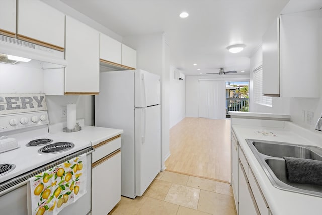 kitchen featuring sink, white appliances, ceiling fan, light tile patterned floors, and white cabinets