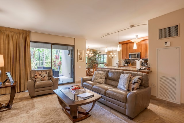 living room with a chandelier and sink