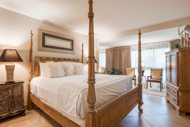 bedroom with light tile patterned floors