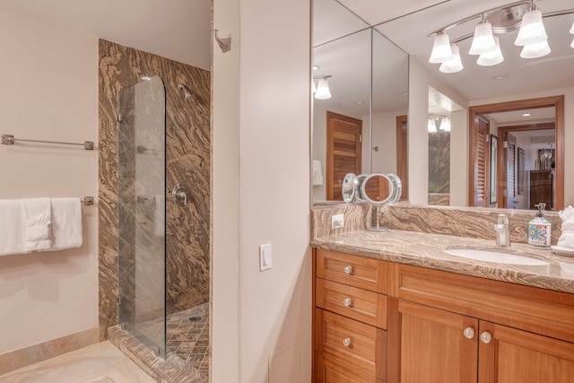 bathroom featuring vanity, a tile shower, and tile patterned floors