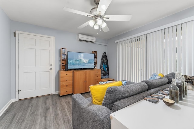 living room featuring an AC wall unit, hardwood / wood-style floors, and ceiling fan