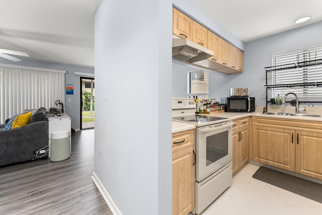 kitchen with light brown cabinetry, light wood-type flooring, ceiling fan, sink, and white electric range oven