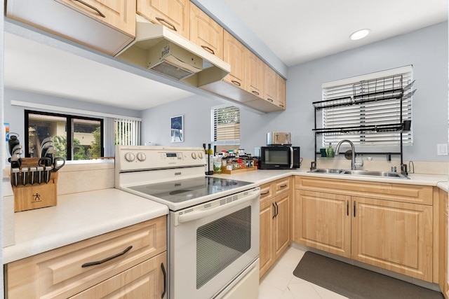 kitchen with light tile patterned floors, sink, white electric stove, and light brown cabinetry