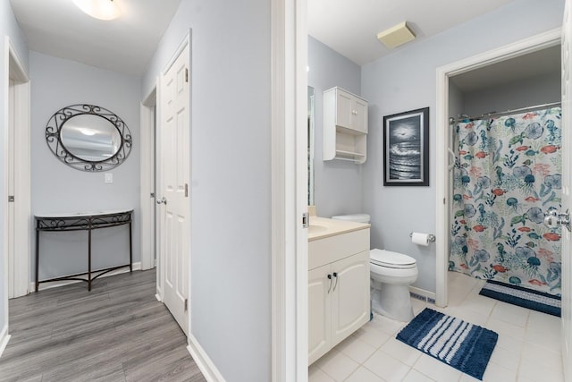 bathroom featuring vanity, tile patterned flooring, and toilet