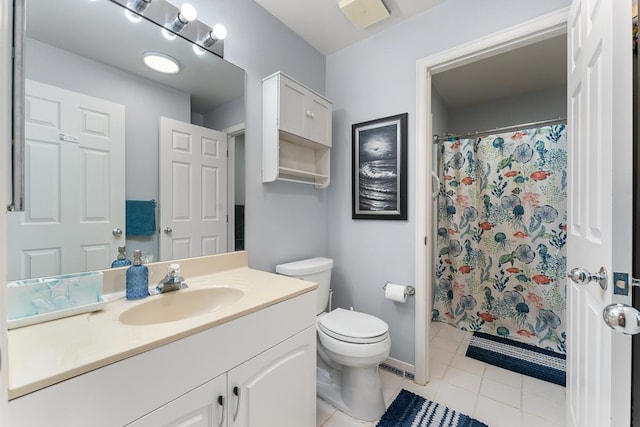 bathroom with vanity, toilet, and tile patterned flooring