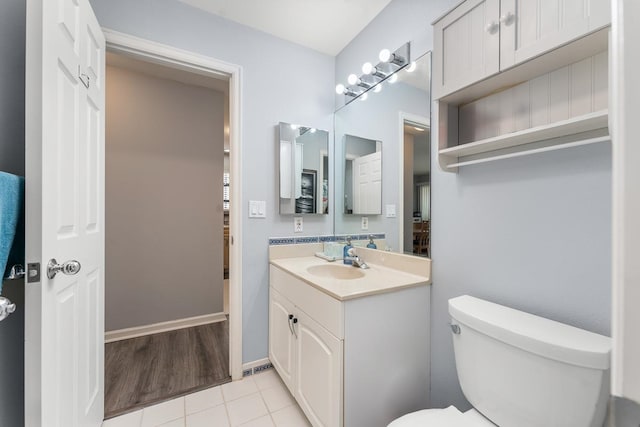 bathroom featuring toilet, tile patterned floors, and vanity