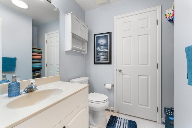 bathroom featuring vanity, tile patterned flooring, and toilet