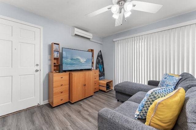 living room with ceiling fan, hardwood / wood-style flooring, and a wall mounted air conditioner