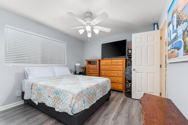 bedroom featuring hardwood / wood-style floors and ceiling fan