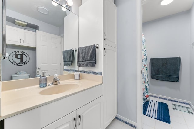 bathroom with vanity, toilet, and tile patterned flooring