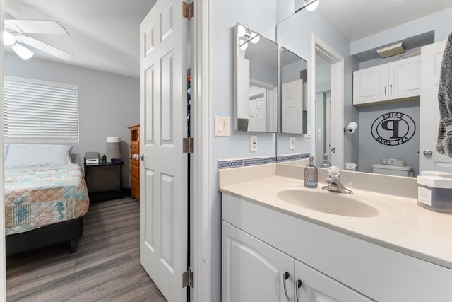 bathroom with ceiling fan, vanity, toilet, and hardwood / wood-style floors