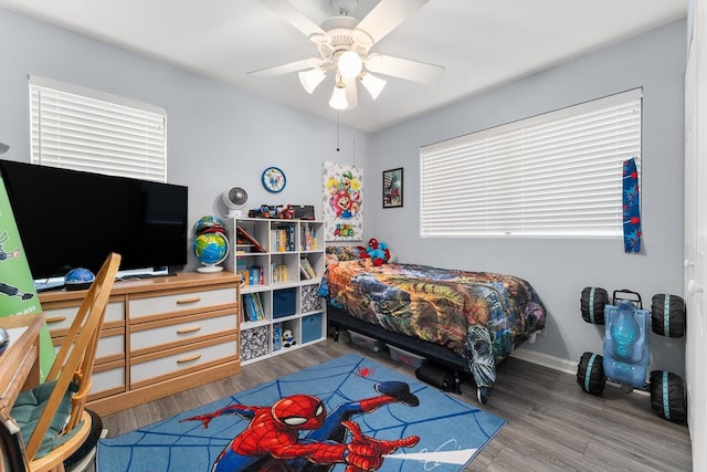 bedroom with ceiling fan and wood-type flooring