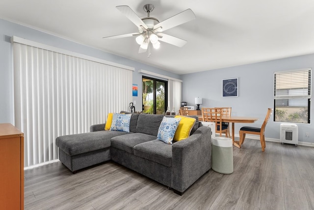 living room featuring ceiling fan and hardwood / wood-style flooring