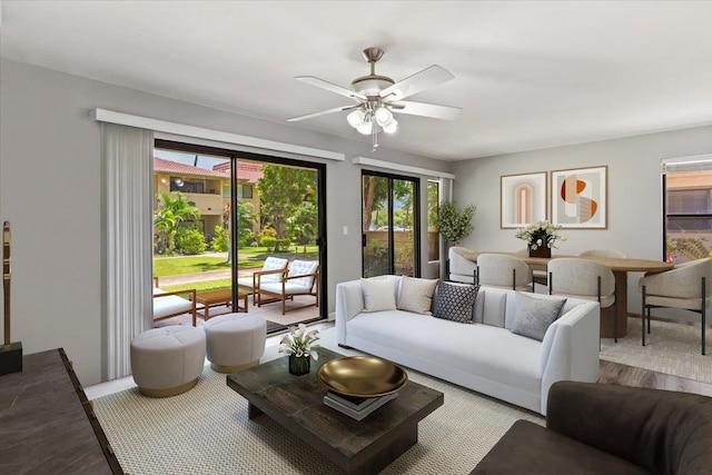 living room with ceiling fan and light wood-type flooring