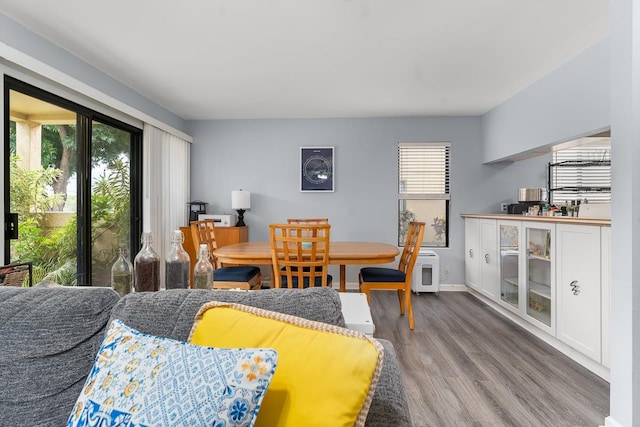 dining space with wood-type flooring