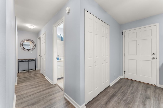 corridor with hardwood / wood-style floors