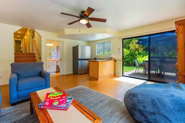 living room with ceiling fan and wood-type flooring