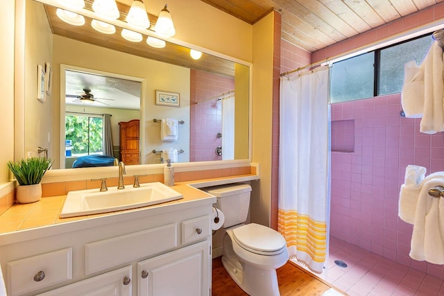 bathroom with ceiling fan, hardwood / wood-style floors, toilet, vanity, and a shower with shower curtain