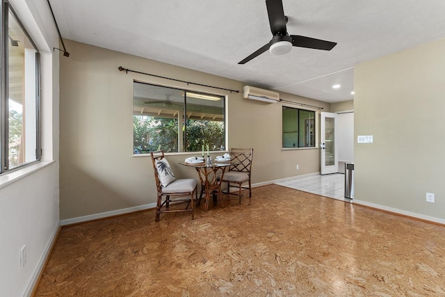 dining space with ceiling fan, light tile patterned floors, and a wall mounted AC