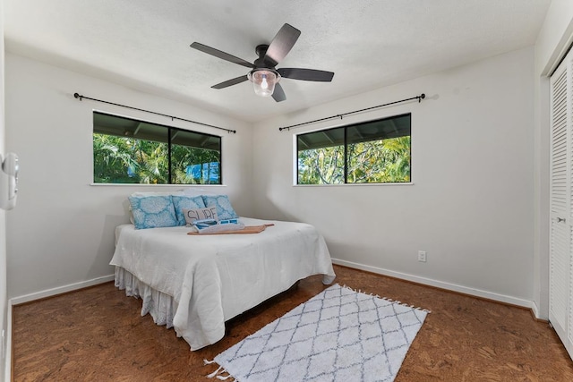 bedroom with ceiling fan and a closet