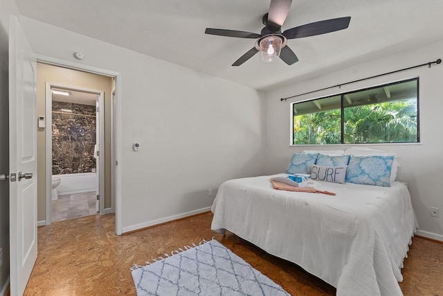 bedroom with ensuite bathroom and ceiling fan