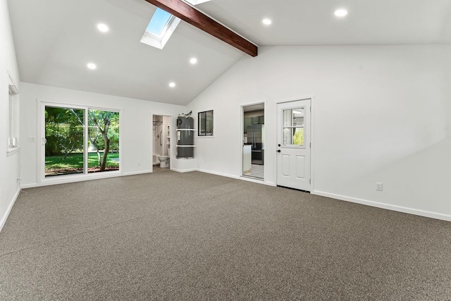 unfurnished living room with lofted ceiling with skylight and carpet