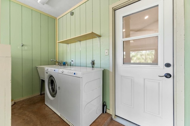 laundry room featuring wood walls and hookup for an electric dryer